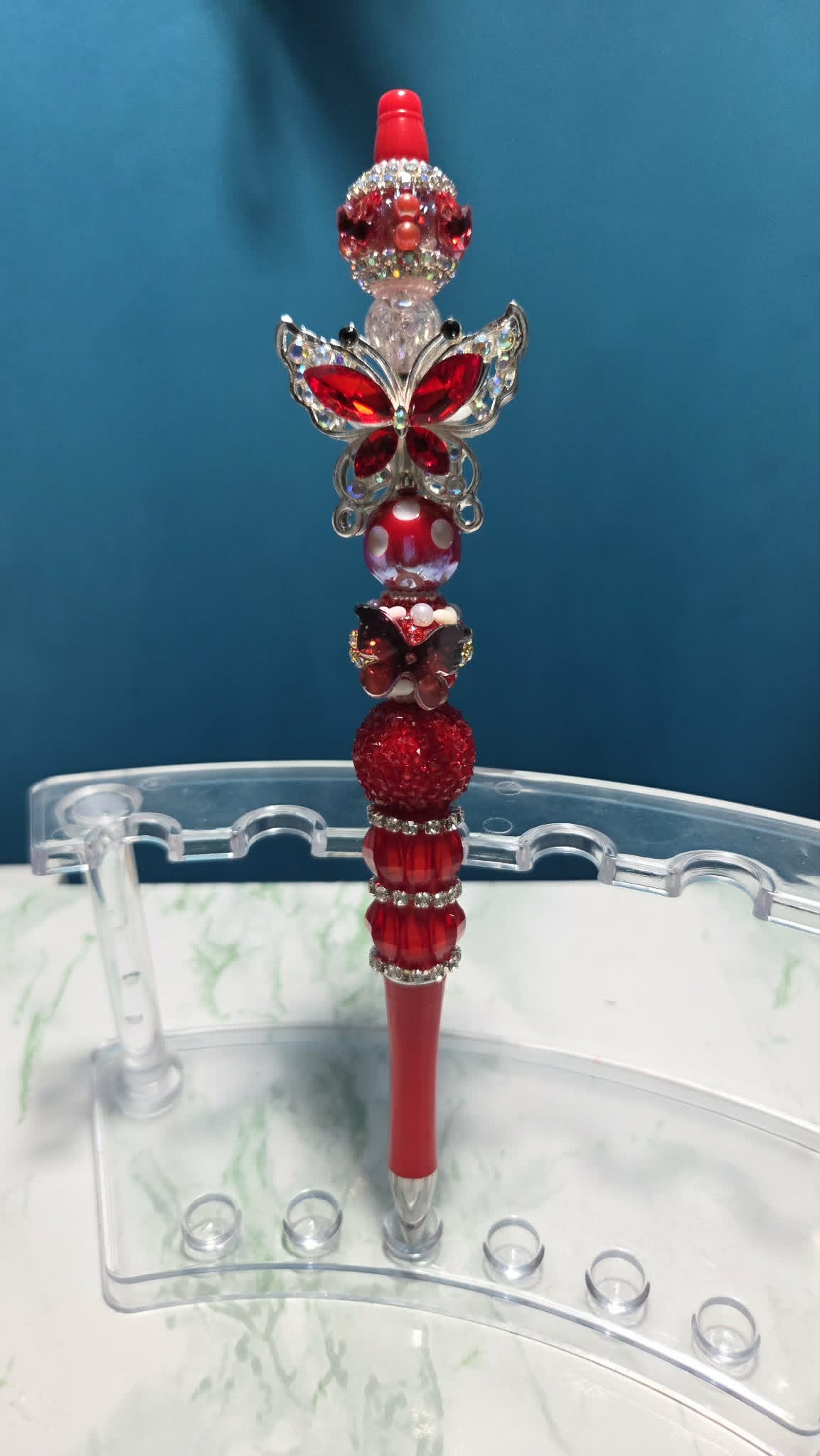Butterfly Folly Red Beadable Pen with rich red crystal butterfly charm and layered red rhinestone beads